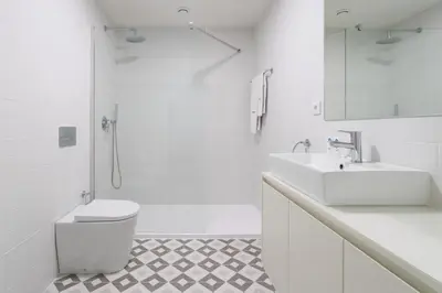 a white bathroom with a toilet and a sink at Stylish Studio in Porto Downtown by HostWise in Porto