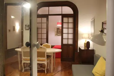 a living room with a table and chairs and a dining room at Downtown Classic Apartment in Porto