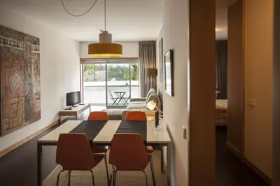 a living room with a dining room table and chairs at Casa do Sol in Porto