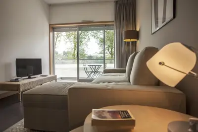 a hotel room with a bed and a television at Casa do Sol in Porto