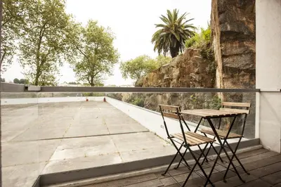 a table and two chairs sitting on a balcony at Casa do Sol in Porto