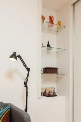 a room with a lamp and shelves on the wall at HostWise - Artistic Escape with Modern Comfort in Vila Nova de Gaia