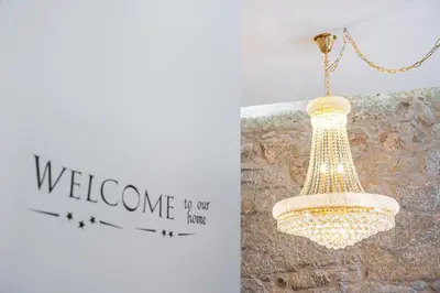 a chandelier hanging from a wall with a welcome sign at GuestReady - Boutique style loft in Constitution in Porto