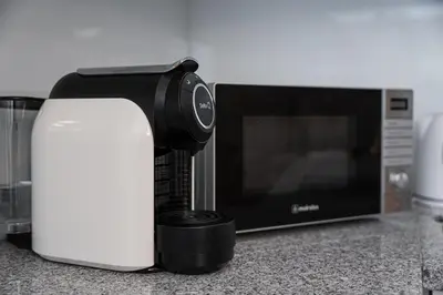 a kitchen counter with a coffee maker and a microwave at GuestReady - Boutique style loft in Constitution in Porto