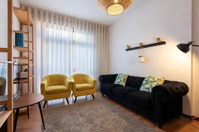 a living room with a couch and two chairs at Botanic Jungle at Porto Downtown in Porto