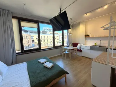 two beds in a room with white sheets at Trindade Studio by Portomosa in Porto