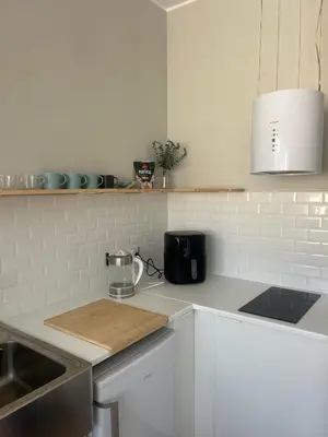 a kitchen with a counter top with a cutting board at Trindade Studio by Portomosa in Porto