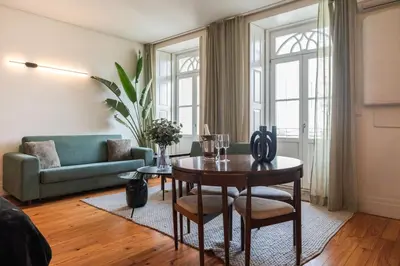 a living room with a table and a couch at The Luxe Cube Apartment in Porto