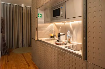 a kitchen with a sink and a microwave at The Luxe Cube Apartment in Porto