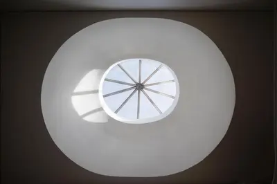 a white circle with a window on a wall at The Luxe Cube Apartment in Porto