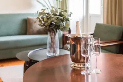 a table with two wine glasses and a bottle on it at The Luxe Cube Apartment in Porto