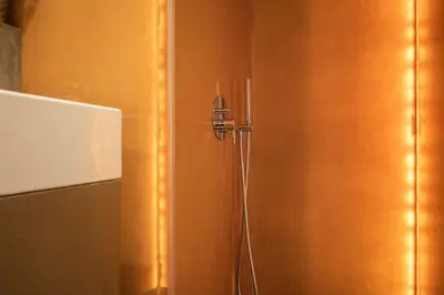 a shower door with a hose in a bathroom at The Luxe Cube Apartment in Porto