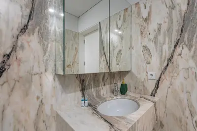 a bathroom with a sink and a mirror at GuestReady - The Citrus Glaze at the Terrace in Porto