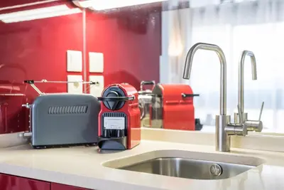 a kitchen counter with a mixer on a sink at GuestReady - Fabric in Colors in Porto