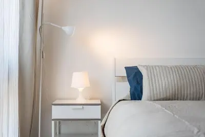 a bedroom with a bed and a lamp on a night stand at GuestReady - Fabric in Colors in Porto