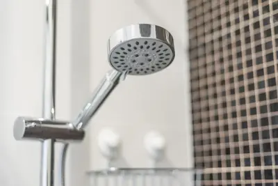 a shower head in a bathroom with a building at GuestReady - Fabric in Colors in Porto