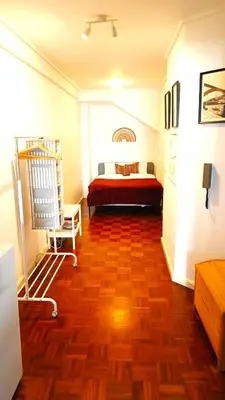 a bedroom with a bed and a wooden floor at Porto Downtown in Porto