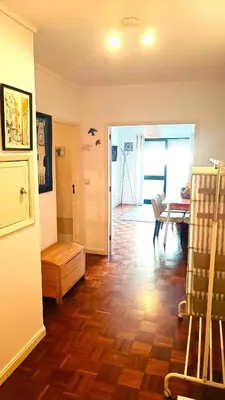 a living room with a wooden floor and a dining room at Porto Downtown in Porto
