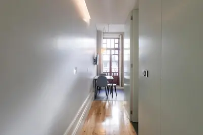 a hallway with a table and a dining room at ApartmentsPorto - Rua de Trás 156 in Porto