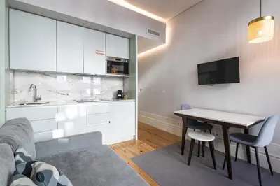 a living room with a table and a kitchen at ApartmentsPorto - Rua de Trás 156 in Porto