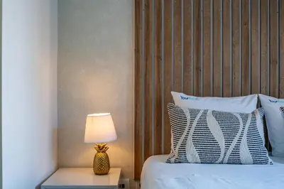 a bedroom with a bed with a lamp on a table at Bellevue Oporto Downtown in Porto