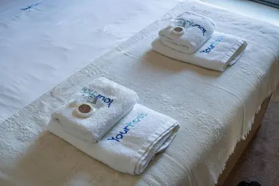 two towels are sitting on a white table at Bellevue Oporto Downtown in Porto