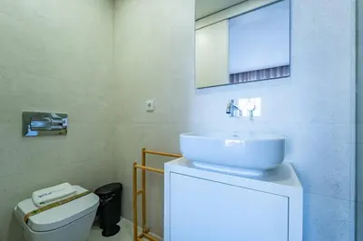 a bathroom with a sink and a toilet at Bellevue Oporto Downtown in Porto
