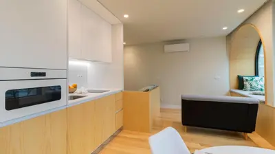 a dining room with a white table and a large window at Charming apartment frente in Porto