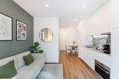 a living room with a couch and a kitchen at GuestReady - Restful haven in Porto in Porto
