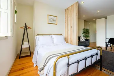 a bedroom with a large bed with white sheets at GuestReady - Hope Apartments in Porto