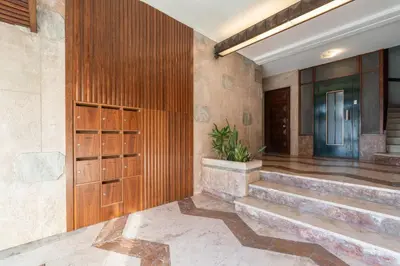 a lobby with stairs and a wooden door at Bright & Spacious Retreat with Balcony by HostWise in Porto