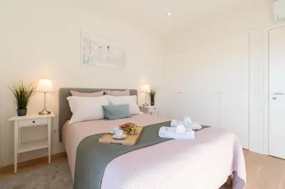 a bedroom with a bed with a tray of food on it at Bright & Spacious Retreat with Balcony by HostWise in Porto