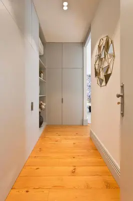 a hallway with a door and wooden floor at BOUTiQUE Rentals- THE MiRaDOURO Ribeira Apartment in Porto