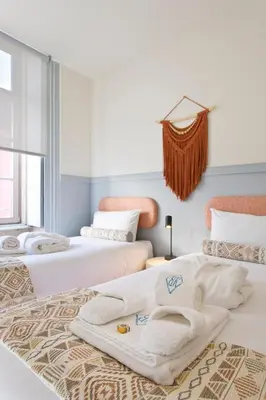 a room with three beds with towels on them at BOUTiQUE Rentals- THE MiRaDOURO Ribeira Apartment in Porto