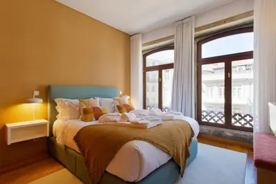 a bedroom with a bed with towels on it at Boutique Rentals-SãO bEnTo Ribeira Apt in Porto