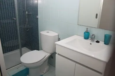 a bathroom with a toilet and a sink and a shower at T3 suites com vistas rio Douro in Vila Nova de Gaia