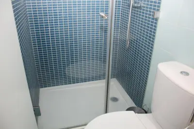 a bathroom with a shower with a toilet and a sink at T3 suites com vistas rio Douro in Vila Nova de Gaia