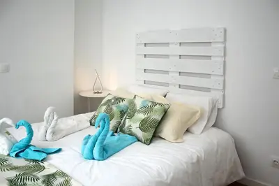 a white bed with stuffed animals on top of it at T2 suites com vistas rio Douro in Vila Nova de Gaia