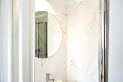 a bathroom with a mirror and a sink at T2 suites com vistas rio Douro in Vila Nova de Gaia