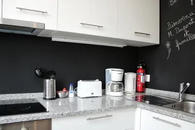 a kitchen with white cabinets and a counter top at T2 suites com vistas rio Douro in Vila Nova de Gaia