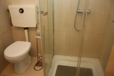 a small bathroom with a toilet and a shower at Estúdio com vistas rio Douro in Vila Nova de Gaia