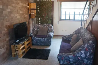 a living room with a couch and a tv at Casa no centro histórico in Vila Nova de Gaia