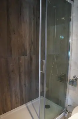 a shower with a glass door in a bathroom at Casa no centro histórico in Vila Nova de Gaia