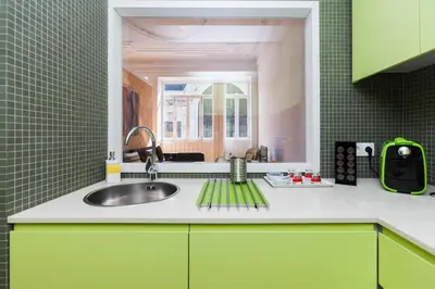 a kitchen with green cabinets and a sink at BO - Sá da Bandeira in Porto