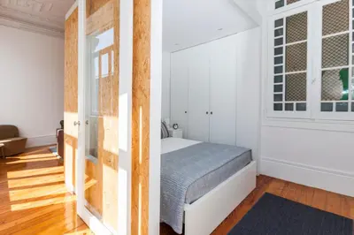 a bedroom with a bed and a window at BO - Sá da Bandeira in Porto