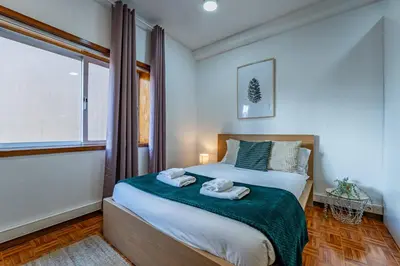 a bedroom with a bed with two towels on it at Oporto Center at Your Doorstep 1 in Porto