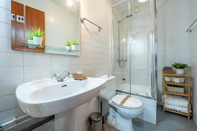 a bathroom with a sink and a toilet and a shower at Oporto Center at Your Doorstep 1 in Porto