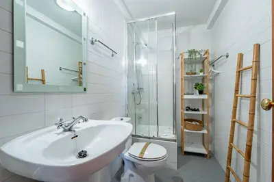 a white bathroom with a sink and a toilet at Oporto Center at Your Doorstep 1 in Porto