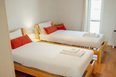 a room with two twin beds and a window at Bright Deluxe by Hosty in Porto