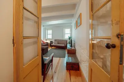 a hallway with a door and a living room at Historical Duplex by Hosty in Porto